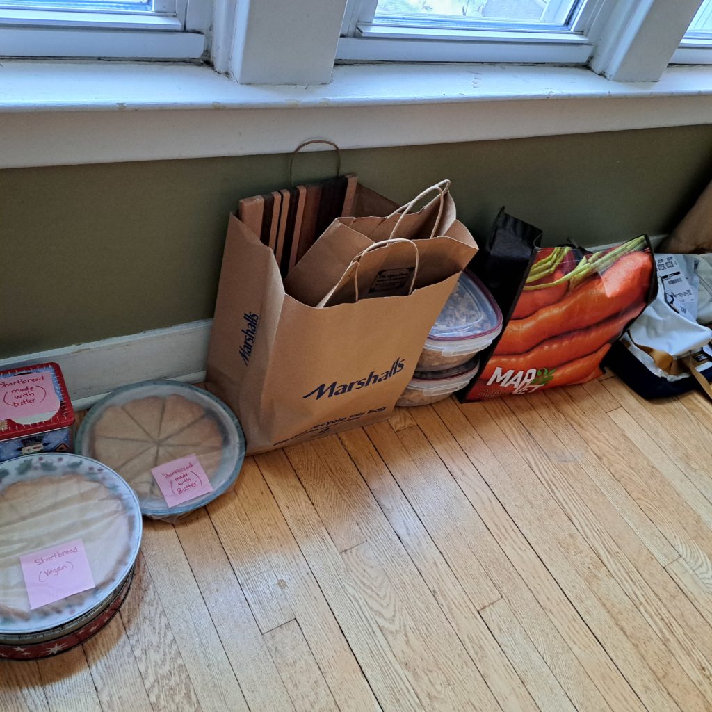 stacks of cookies and treats and bags lined up along a wall